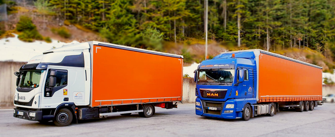 Logistics worker standing in a large warehouse checking shipping boxes